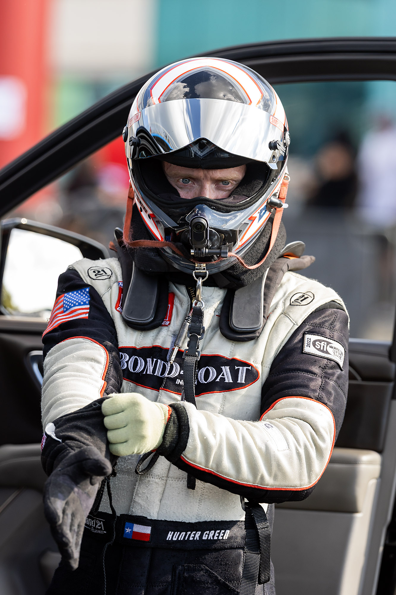 Hunter Green pulls on his gloves beside the car before a run