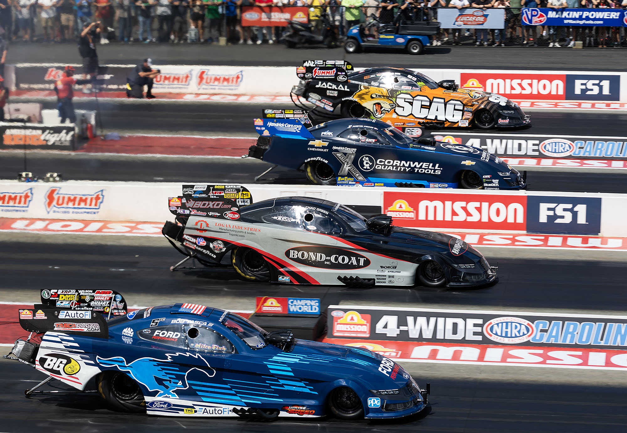 Four Funny Cars launch together at the zMAX Dragway four-wide race