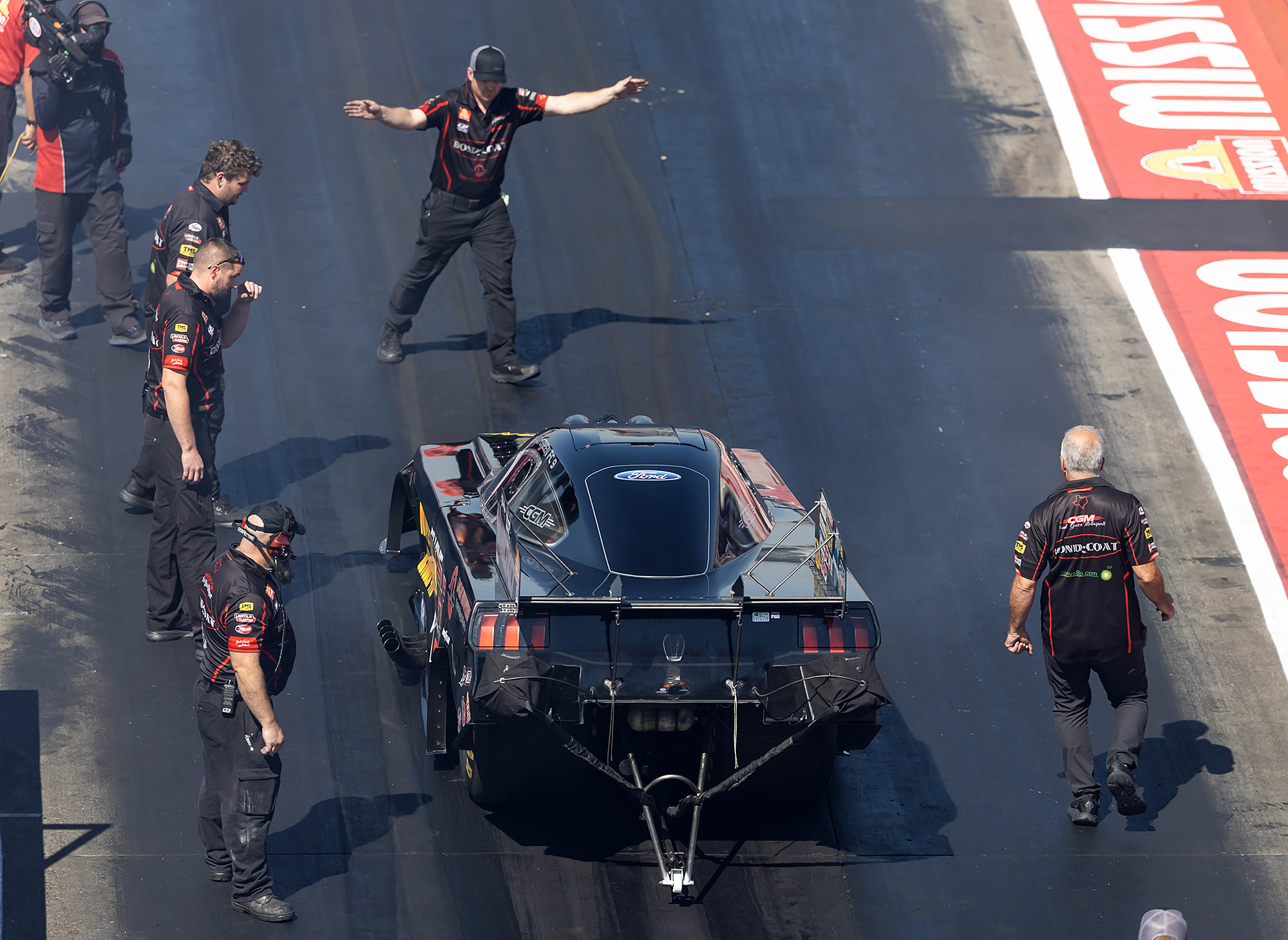 The crew guides the car back down the return road after a run